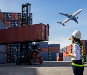 Logistics supervisor monitoring container loading with airplane flying overhead
