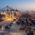Evening operations at a shipping terminal facilitated by an experienced freight forwarder in Saudi Arabia.